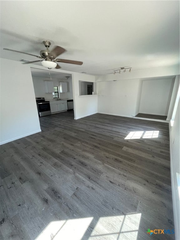 unfurnished living room featuring dark hardwood / wood-style flooring and ceiling fan