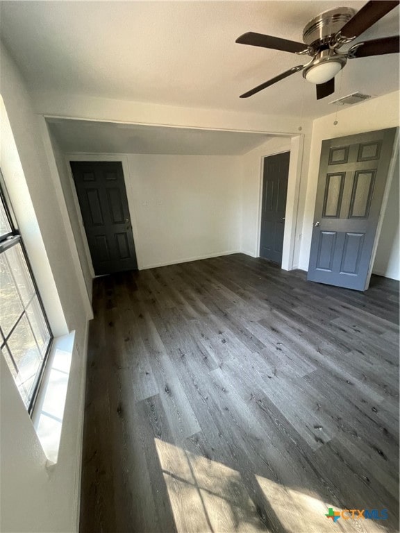 interior space with dark hardwood / wood-style floors and ceiling fan