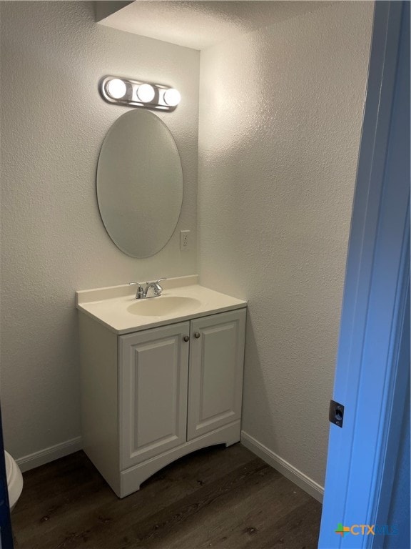 bathroom with wood-type flooring and vanity