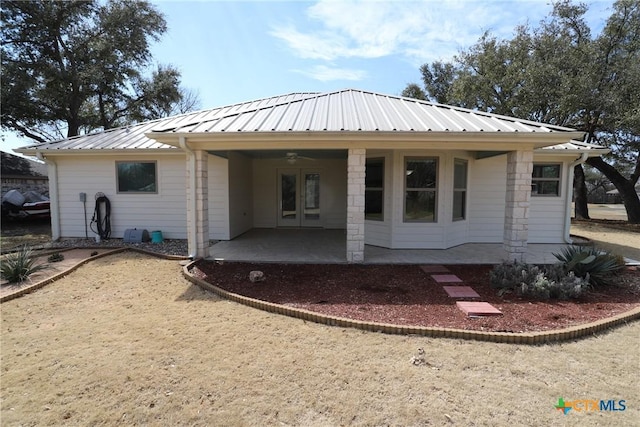 back of property featuring a patio area and metal roof