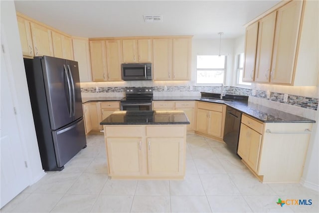 kitchen with stainless steel appliances, visible vents, decorative backsplash, light brown cabinetry, and a sink