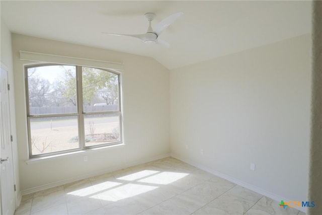 unfurnished room with lofted ceiling, ceiling fan, and baseboards