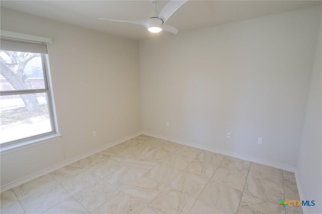 empty room featuring a healthy amount of sunlight, baseboards, and a ceiling fan