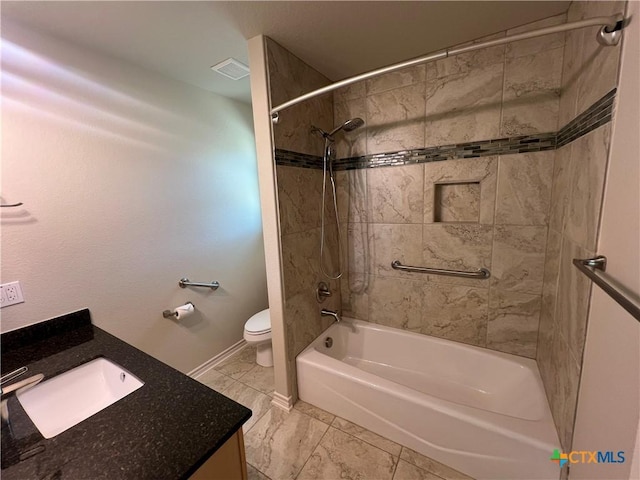 full bath featuring toilet, vanity, visible vents, baseboards, and washtub / shower combination