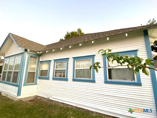 view of property exterior featuring a lawn