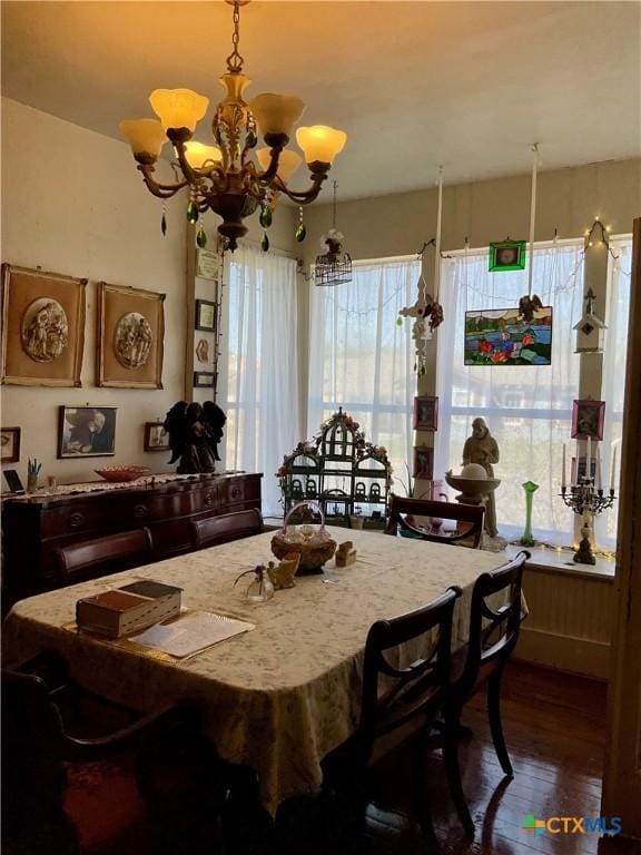 dining room featuring an inviting chandelier and wood finished floors