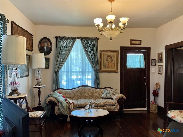 living area with a notable chandelier and wood finished floors