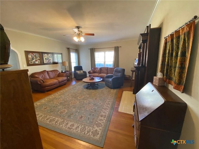 living room with crown molding, ceiling fan, and hardwood / wood-style flooring