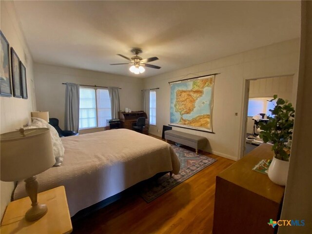 bedroom featuring ceiling fan and dark wood-type flooring