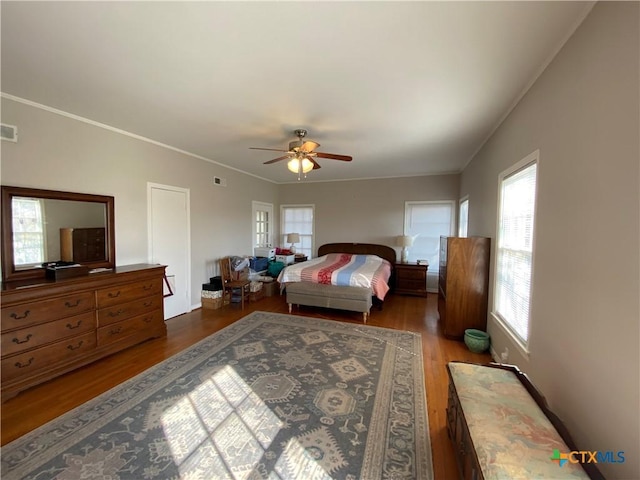 bedroom featuring ceiling fan, dark hardwood / wood-style floors, and ornamental molding