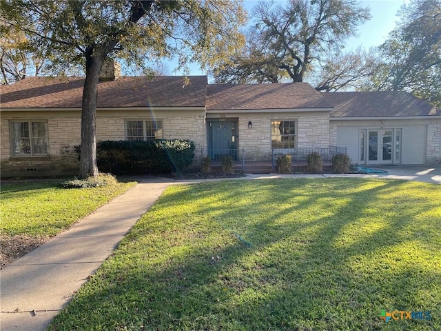 ranch-style house with french doors and a front lawn