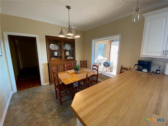 dining area featuring ceiling fan with notable chandelier and crown molding