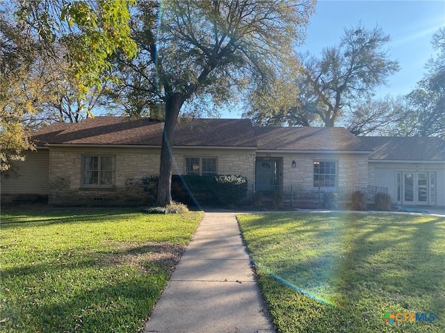 ranch-style home with a front yard