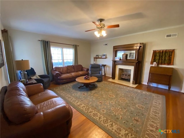 living room with wood-type flooring and ceiling fan