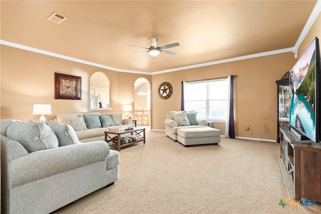 living room with carpet flooring, ceiling fan, a textured ceiling, and ornamental molding