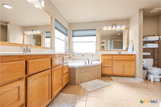 full bathroom with tile patterned floors, vanity, toilet, and plus walk in shower