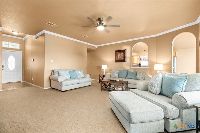 living room with carpet floors, ceiling fan, and crown molding