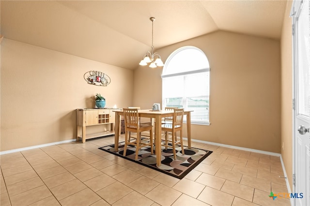 tiled dining area featuring a notable chandelier and vaulted ceiling