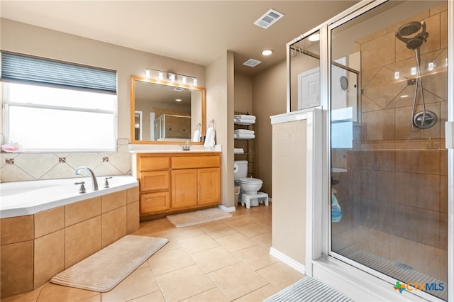 full bathroom with tile patterned floors, toilet, vanity, and shower with separate bathtub