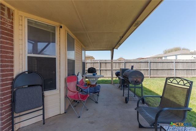 view of patio / terrace featuring area for grilling and fence