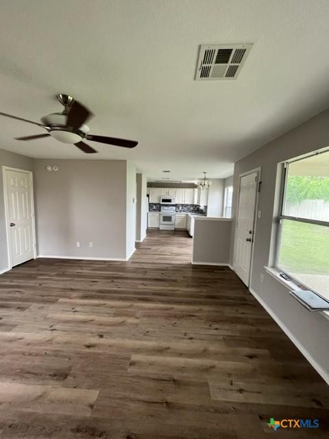 5408 Donegal Bay Ct, Killeen, TX 76549 - unfurnished living room with dark wood-style floors and ceiling fan