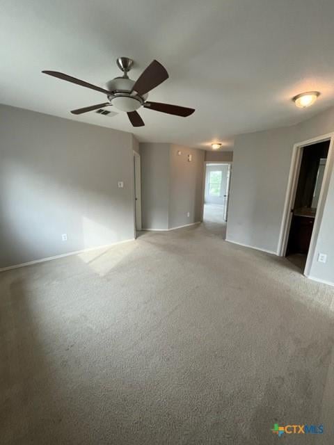 unfurnished room with baseboards, light carpet, a ceiling fan, and visible vents