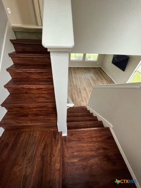 staircase with wood finished floors