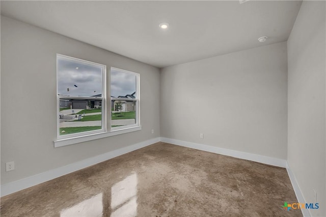 2402 Healy Dr, Temple, TX 76502 - spare room with concrete flooring, baseboards, a smoke detector, and recessed lighting