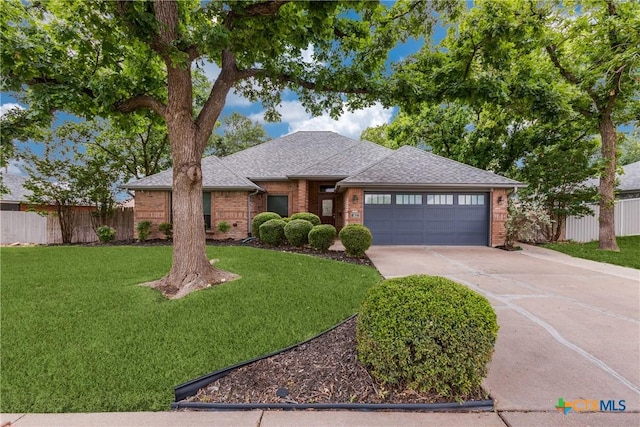 1812 Bowen Ave, Copperas Cove, TX 76522 - view of front facade featuring brick siding, a garage, concrete driveway, and roof with shingles