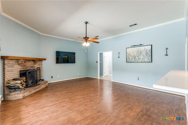 1812 Bowen Ave, Copperas Cove, TX 76522 - unfurnished living room with crown molding, wood finished floors, ceiling fan, a brick fireplace, and baseboards