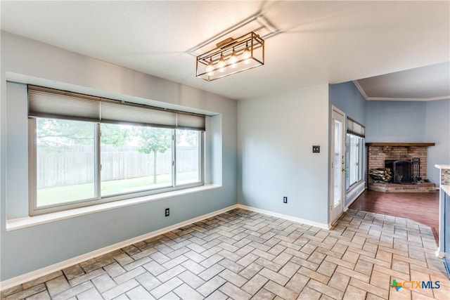1812 Bowen Ave, Copperas Cove, TX 76522 - spare room with healthy amount of natural light, baseboards, a brick fireplace, and ornamental molding