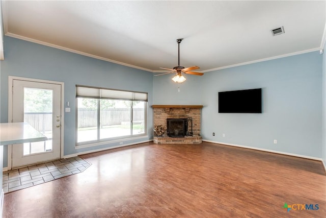 1812 Bowen Ave, Copperas Cove, TX 76522 - unfurnished living room featuring crown molding, wood finished floors, ceiling fan, baseboards, and a fireplace