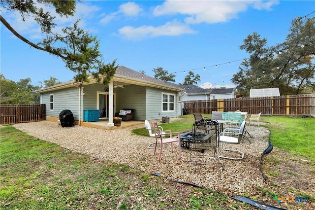 rear view of property featuring a yard and a patio