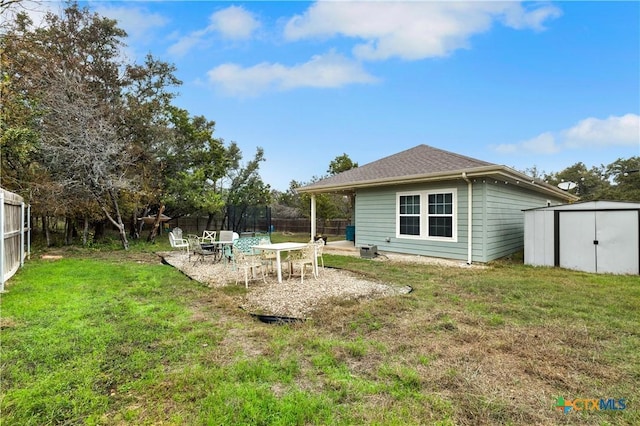 rear view of house with a patio, a trampoline, a storage unit, and a lawn