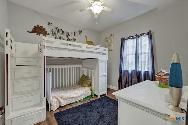 bedroom featuring ceiling fan and dark wood-type flooring