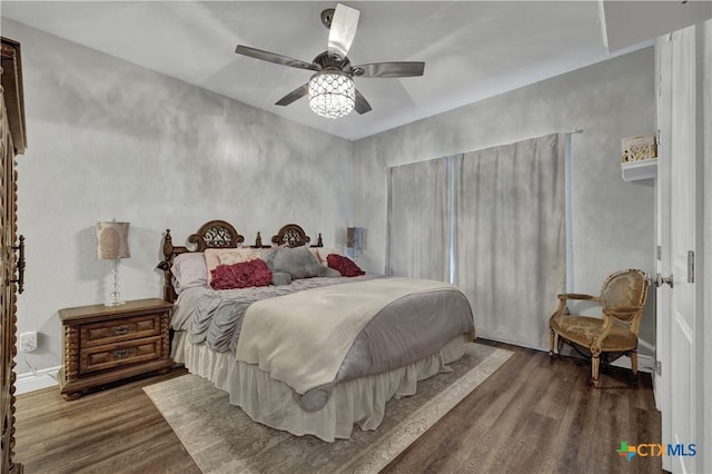 bedroom featuring dark hardwood / wood-style flooring and ceiling fan