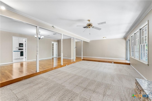 906 Illinois Ave, Killeen, TX 76541 - unfurnished living room featuring ornamental molding, baseboards, a ceiling fan, wood finished floors, and carpet