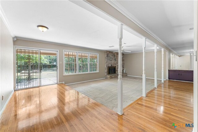 906 Illinois Ave, Killeen, TX 76541 - unfurnished living room featuring wood finished floors, ornamental molding, a fireplace, and baseboards