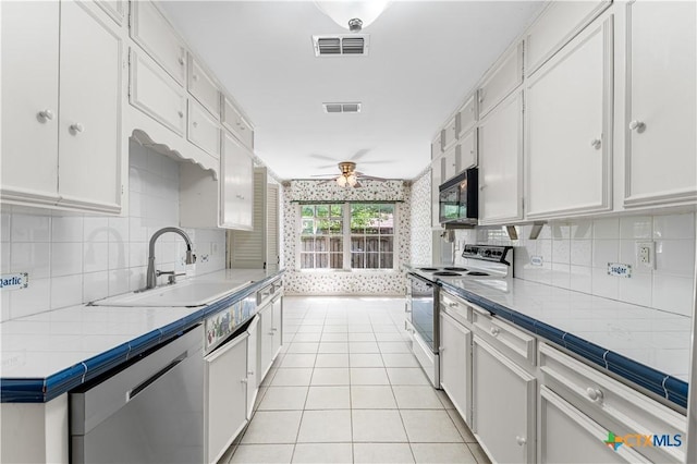906 Illinois Ave, Killeen, TX 76541 - kitchen featuring white range with electric stovetop, stainless steel dishwasher, ceiling fan, white cabinets, and a sink