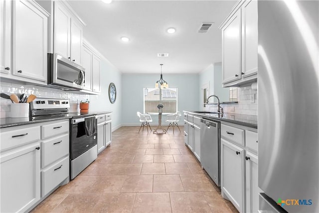 2655 Belle Hubbard Trl, Belton, TX 76513 - kitchen featuring appliances with stainless steel finishes, tasteful backsplash, dark countertops, white cabinets, and recessed lighting
