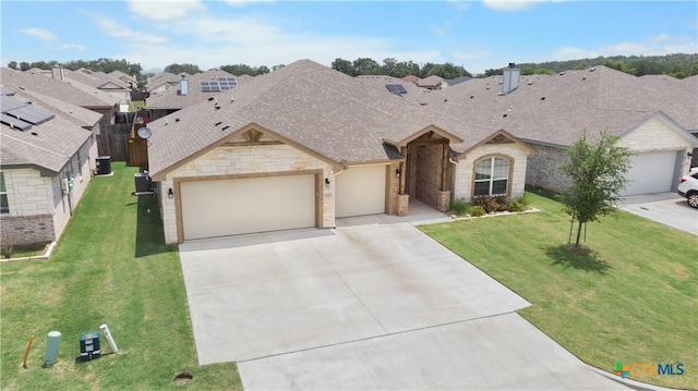 2655 Belle Hubbard Trl, Belton, TX 76513 - view of front of home with stone siding, an attached garage, concrete driveway, a residential view, and roof with shingles