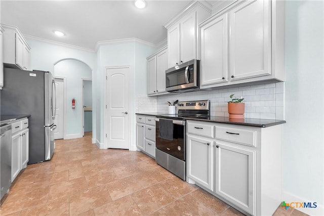 2655 Belle Hubbard Trl, Belton, TX 76513 - kitchen with appliances with stainless steel finishes, arched walkways, backsplash, dark countertops, and crown molding