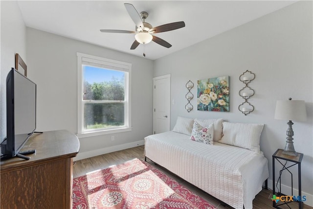 bedroom featuring baseboards, ceiling fan, and wood finished floors