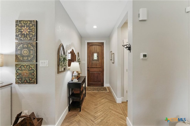 doorway featuring baseboards and recessed lighting