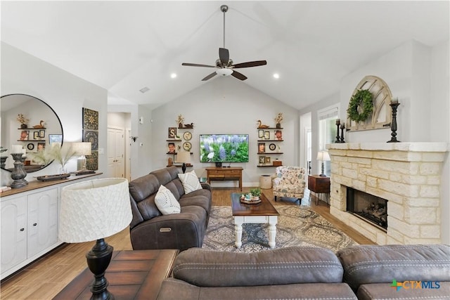 living room featuring a ceiling fan, a fireplace, vaulted ceiling, wood finished floors, and recessed lighting