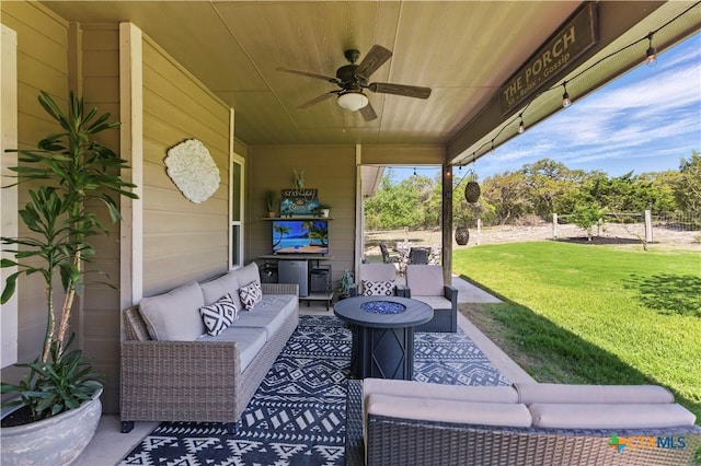 view of patio / terrace featuring an outdoor living space with a fire pit and ceiling fan