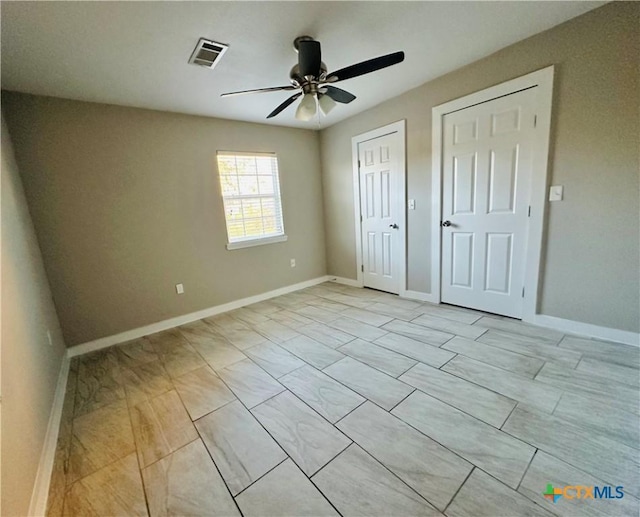 unfurnished bedroom featuring ceiling fan