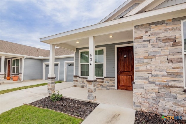 view of exterior entry with a porch