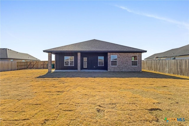 rear view of property with a patio area and a yard