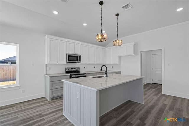 kitchen featuring light stone countertops, appliances with stainless steel finishes, sink, a center island with sink, and white cabinets